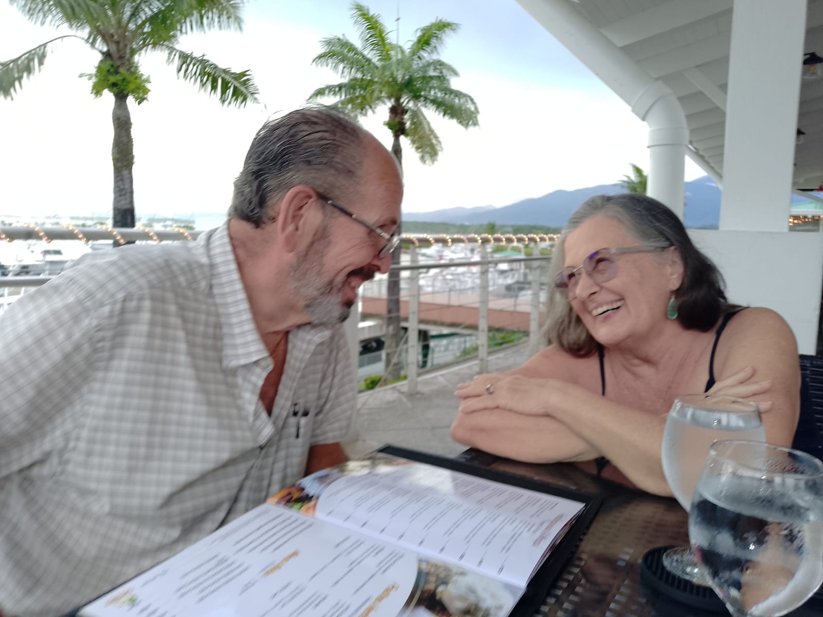 John and Lori laughing together at a table